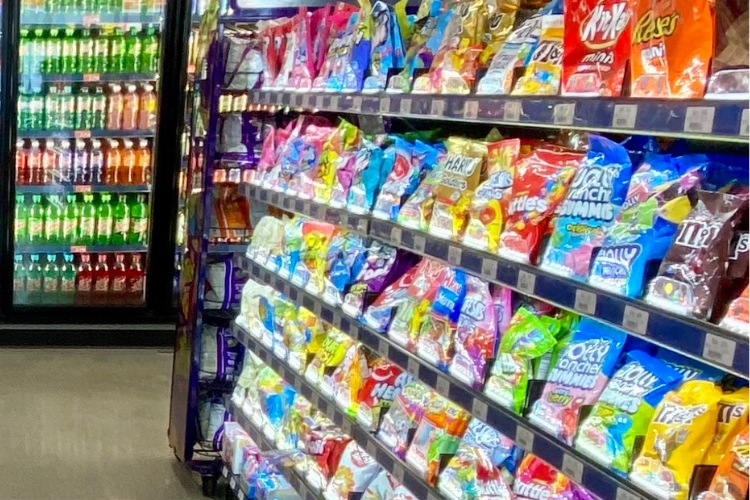A retail display unit with pushers filled with candy