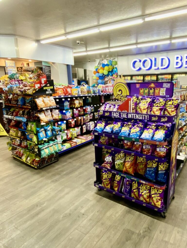 Retail gondolas in a store with a variety of snacks on display